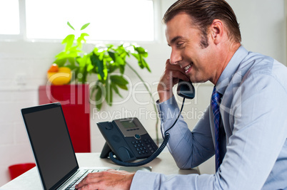 Side profile of a businessman busy in office work