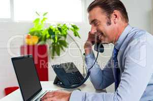 Side profile of a businessman busy in office work