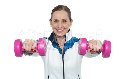 Female working out with pink dumbbells