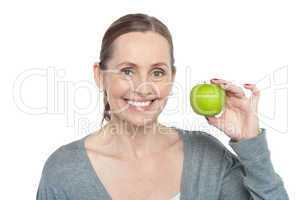 Health conscious woman holding fresh green apple