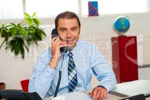 Smiling businessman attending work call