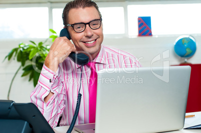 Happy executive engaged on a business call