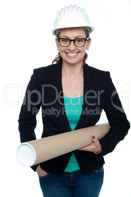 Confident female architect carrying blueprints