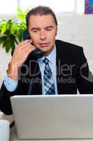 Man in formal attire talking on the phone