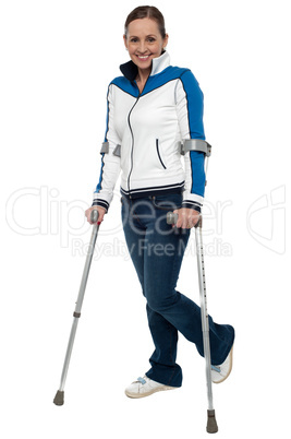 Woman walking with the support of crutches