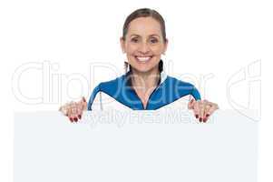 Charming woman holding blank whiteboard
