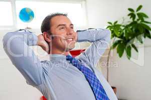 Young businessman relaxing and day dreaming