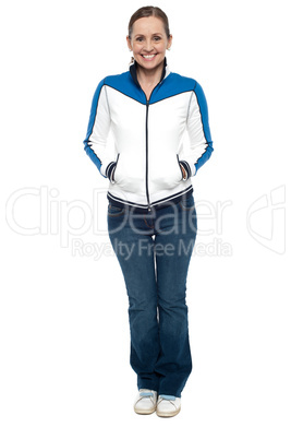 Stylish woman posing with hands in jackets pocket