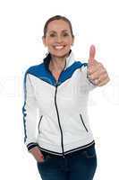 Joyous woman showing thumbs up gesture