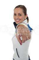 Cheerful woman standing sideways and pointing at you