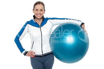 Pretty woman holding big blue pilate ball