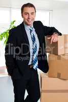 Executive with his hand placed on pile of cardboard cartons