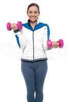 Active woman posing with dumbbells