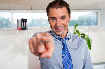 Handsome man in formals pointing at you