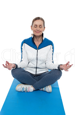 Portrait of a woman sitting in a lotus position
