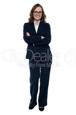 Executive in business attire standing arms folded