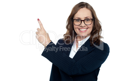 Beautiful executive in suit gesturing copy space