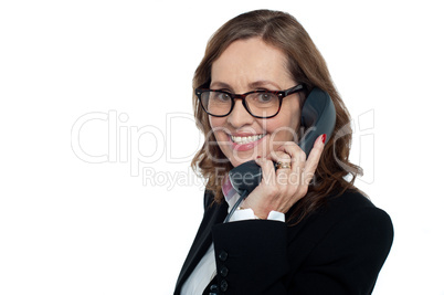 Bespectacled woman talking over the phone