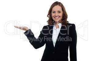 Middle aged corporate woman showing copy space