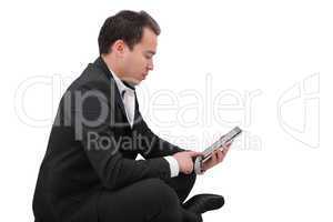 businessman with digital pad touch screen sitting in yoga lotus