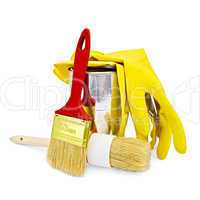 Brushes with yellow gloves and a jar