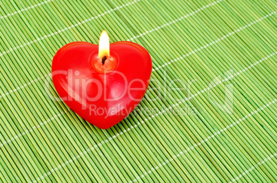 Heart of candles on a green bamboo