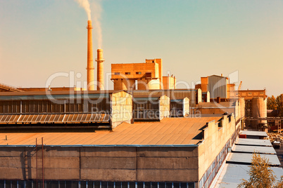 Large factory with smoking chimneys
