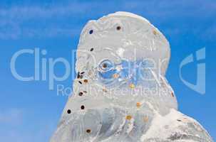 Ice sculpture of Santa Claus over blue sky