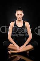 Young Caucasian woman doing yoga legs crossed