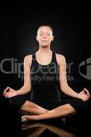 Young woman sitting in lotus position meditating