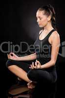Full length of a young woman meditating