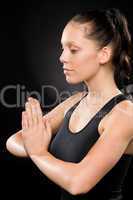 Tranquil woman performing yoga with eyes closed