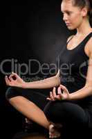 Relaxed young woman exercising in lotus position