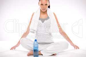 Young woman sitting cross legged after exercises
