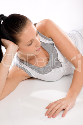 Young woman thinking and relaxing after exercises
