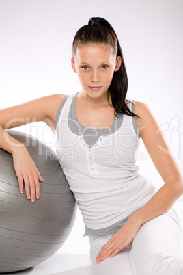 Woman relaxing after exercises with fitness ball