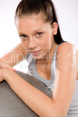 Portrait of woman leaning on fitness ball