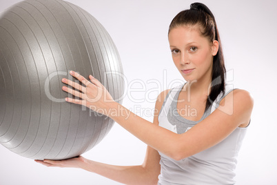 Woman holding fitness ball on white background