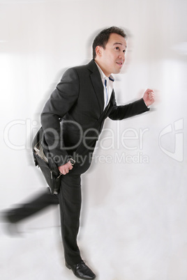 Full length of business man with briefcase running on white back