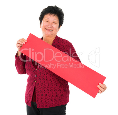Chinese senior woman with red spring couplets