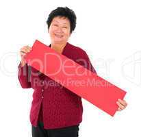 Chinese senior woman with red spring couplets