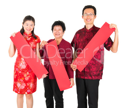 Asian Chinese family holding red spring couplets