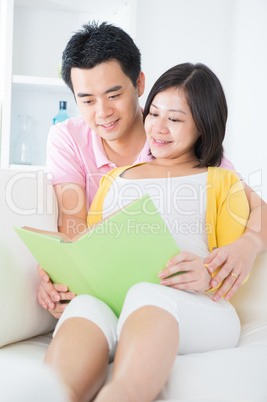 Asian couple reading book