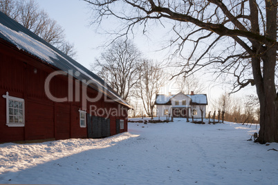 Red painted Swedish wooden house in a wintry landscape