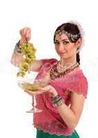 Young girl in the Indian national dress with grapes