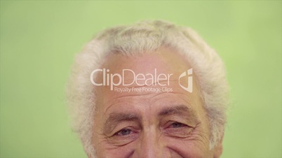 Portrait of happy elderly caucasian man smiling at camera
