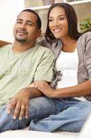 Happy African American Couple Sitting At Home