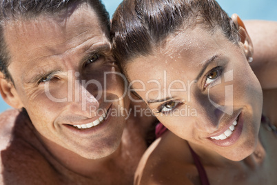 Beautiful Couple Relaxing In Swimming Pool With Perfect Smiles