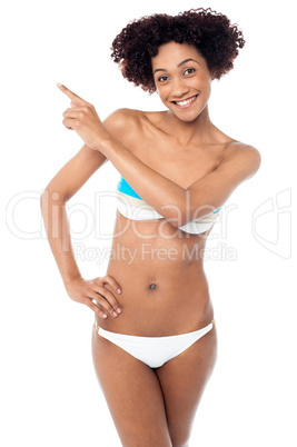 Sexy woman with curvy body pointing sideways