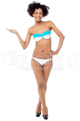 Glamorous woman in swimwear presenting copy space